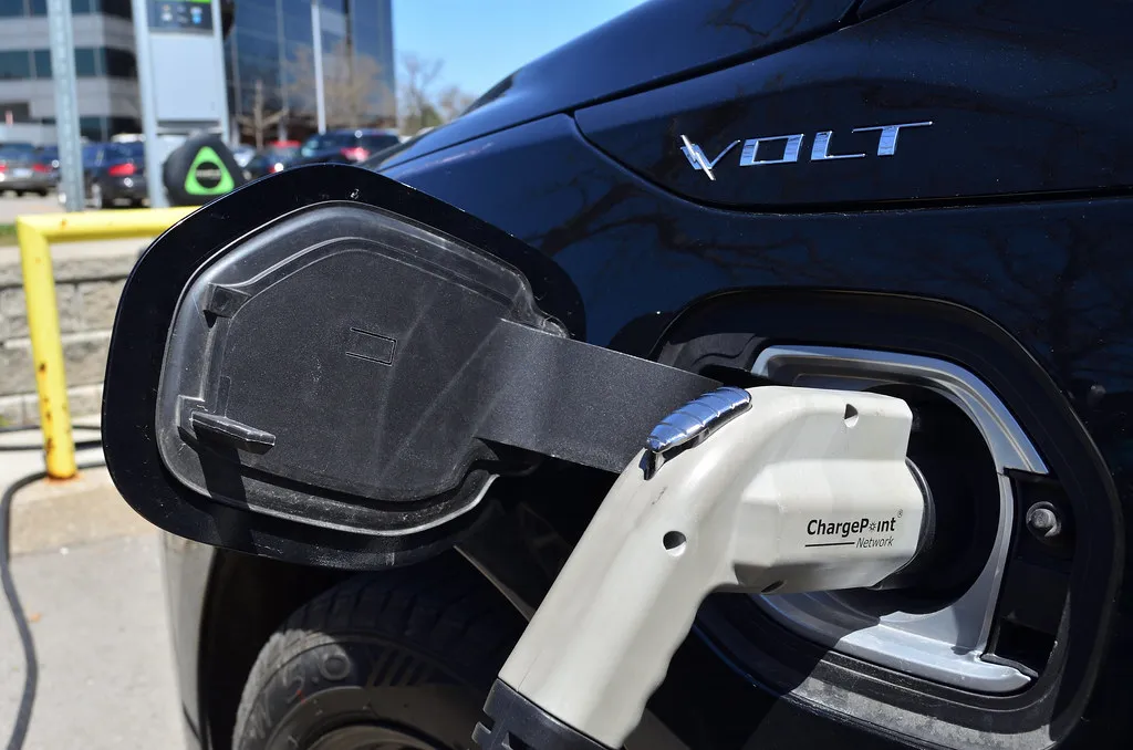 A charging connector plugged into the charge port of an electric car